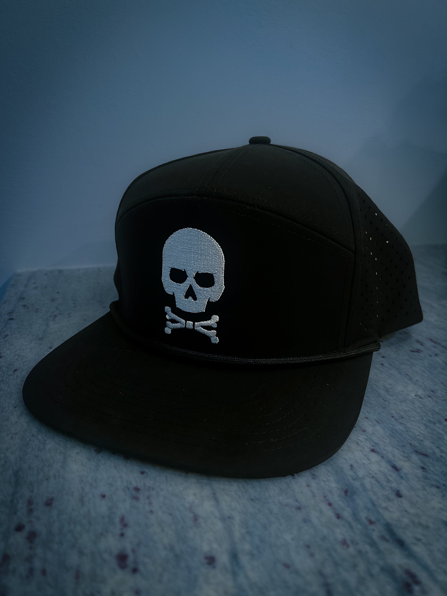 Black flat brim hat with a skull