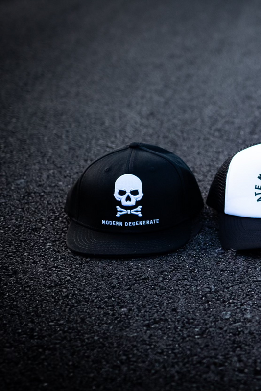 Three white and black hats with skulls on each.