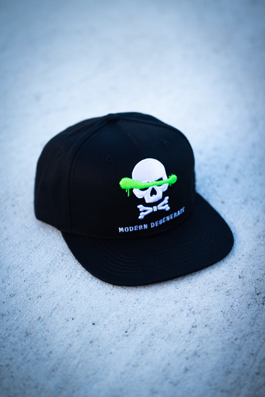 A black, white, and green hat with a skill and crossbones logo